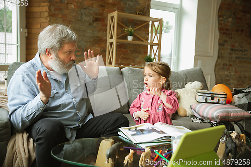 Image of Grandfather and child playing together at home. Happiness, family, relathionship, education concept.