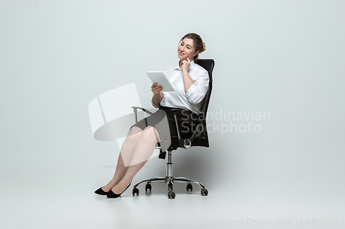 Image of Young caucasian woman in office attire on gray background. Bodypositive female character. plus size businesswoman