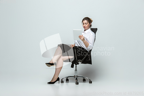 Image of Young caucasian woman in office attire on gray background. Bodypositive female character. plus size businesswoman