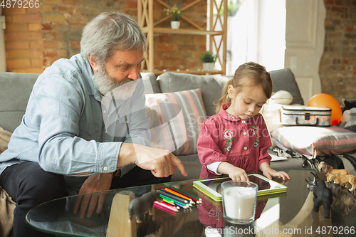 Image of Grandfather and child playing together at home. Happiness, family, relathionship, education concept.