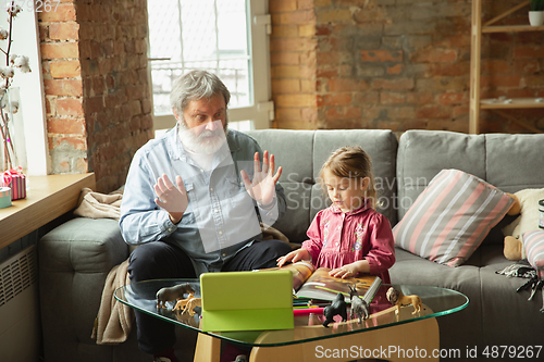 Image of Grandfather and child playing together at home. Happiness, family, relathionship, education concept.