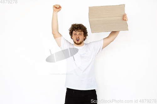 Image of Young man protesting with blank board, sign isolated on white studio background