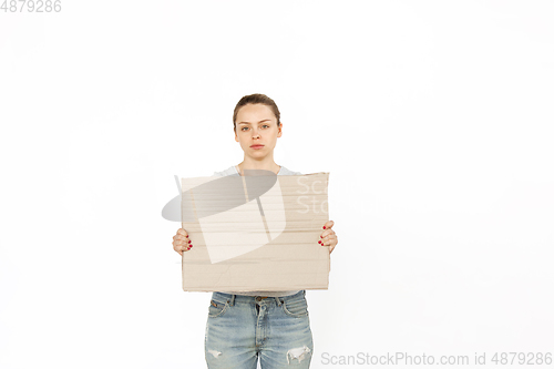 Image of Young woman protesting with blank board, sign isolated on white studio background