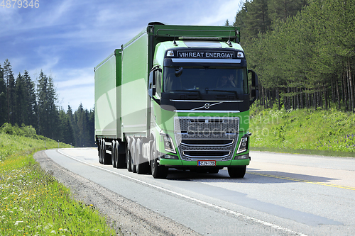 Image of Green Volvo FH16 Truck Woodchip Trailer on Road 