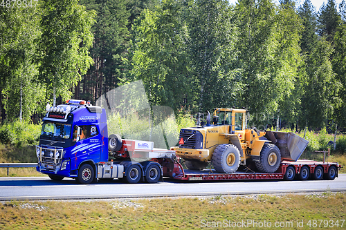 Image of Volvo FH16 Truck Hauls Volvo Wheel Loader on Semi Trailer