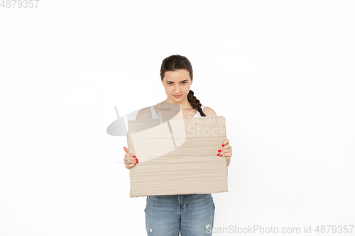 Image of Young woman protesting with blank board, sign isolated on white studio background