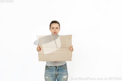 Image of Young woman protesting with blank board, sign isolated on white studio background