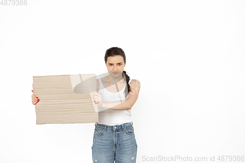 Image of Young woman protesting with blank board, sign isolated on white studio background