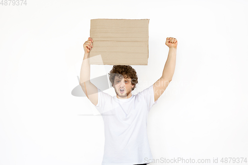 Image of Young man protesting with blank board, sign isolated on white studio background