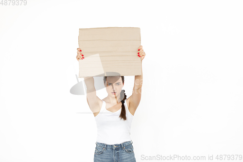 Image of Young woman protesting with blank board, sign isolated on white studio background