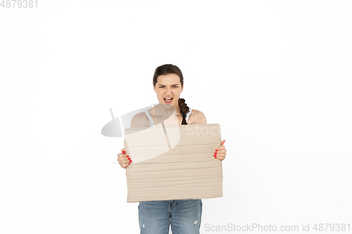 Image of Young woman protesting with blank board, sign isolated on white studio background