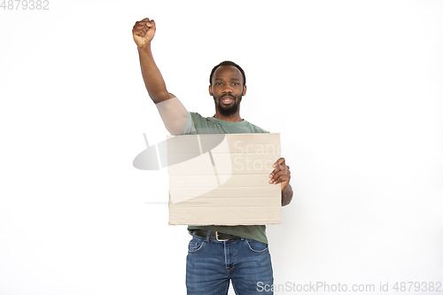 Image of Young man protesting with blank board, sign isolated on white studio background