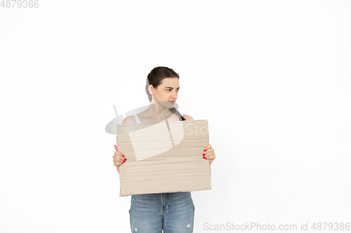 Image of Young woman protesting with blank board, sign isolated on white studio background