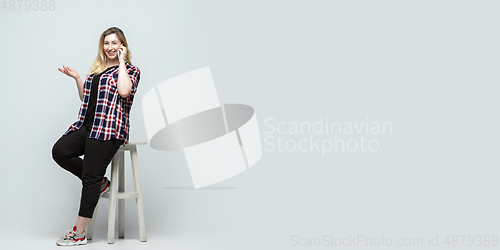 Image of Young caucasian woman in casual wear on gray background. Bodypositive female character, plus size businesswoman