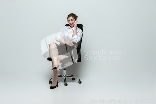 Image of Young caucasian woman in office attire on gray background. Bodypositive female character. plus size businesswoman