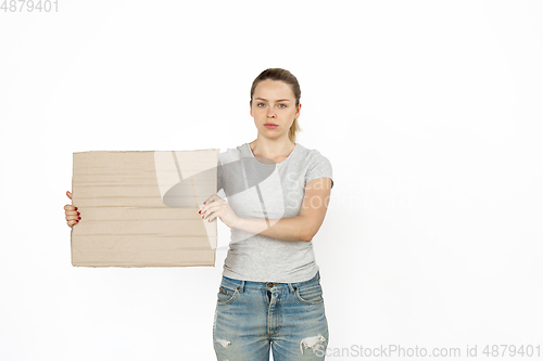 Image of Young woman protesting with blank board, sign isolated on white studio background