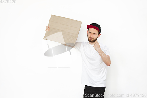 Image of Young man protesting with blank board, sign isolated on white studio background