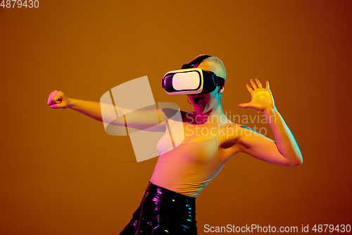 Image of Portrait of young caucasian woman in fashionable eyewear on brown background with copyspace, unusual and freaky appearance