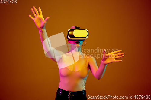 Image of Portrait of young caucasian woman in fashionable eyewear on brown background with copyspace, unusual and freaky appearance