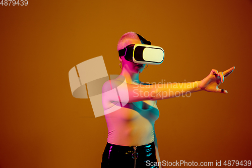 Image of Portrait of young caucasian woman in fashionable eyewear on brown background with copyspace, unusual and freaky appearance