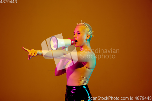 Image of Portrait of young caucasian woman in fashionable eyewear on brown background with copyspace, unusual and freaky appearance