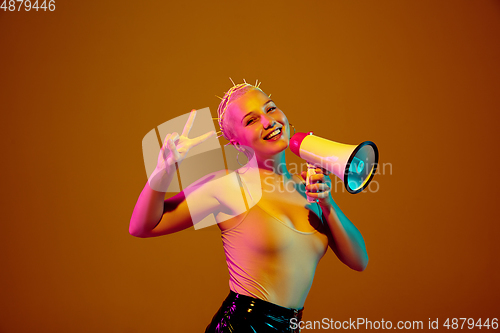 Image of Portrait of young caucasian woman in fashionable eyewear on brown background with copyspace, unusual and freaky appearance