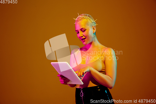 Image of Portrait of young caucasian woman in fashionable eyewear on brown background with copyspace, unusual and freaky appearance