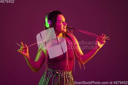 Image of Portrait of young caucasian woman on pink background with copyspace, unusual and freaky appearance