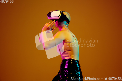 Image of Portrait of young caucasian woman in fashionable eyewear on brown background with copyspace, unusual and freaky appearance