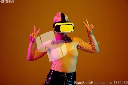 Image of Portrait of young caucasian woman in fashionable eyewear on brown background with copyspace, unusual and freaky appearance