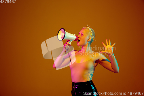 Image of Portrait of young caucasian woman in fashionable eyewear on brown background with copyspace, unusual and freaky appearance