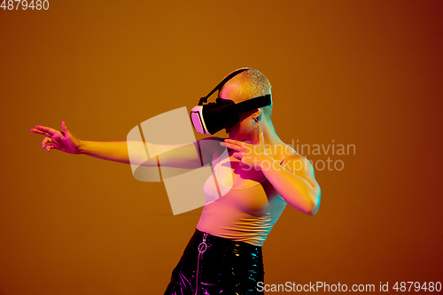 Image of Portrait of young caucasian woman in fashionable eyewear on brown background with copyspace, unusual and freaky appearance