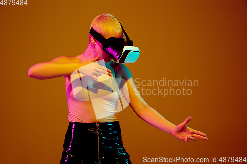 Image of Portrait of young caucasian woman in fashionable eyewear on brown background with copyspace, unusual and freaky appearance