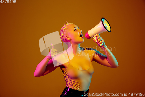 Image of Portrait of young caucasian woman in fashionable eyewear on brown background with copyspace, unusual and freaky appearance