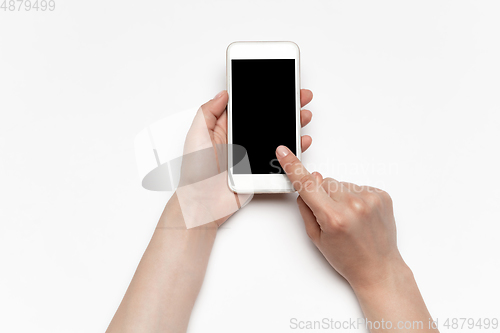 Image of Close up of human hand using smartphone with blank black screen, education and business concept