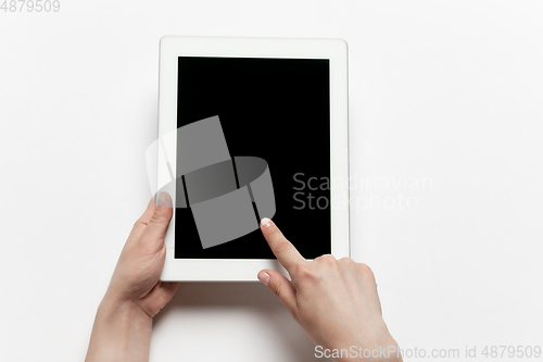 Image of Close up of human hand using tablet with blank black screen, education and business concept