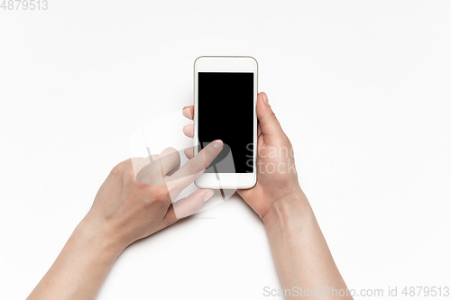 Image of Close up of human hand using smartphone with blank black screen, education and business concept