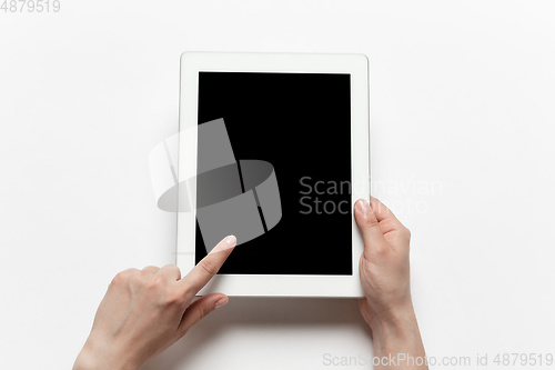 Image of Close up of human hand using tablet with blank black screen, education and business concept