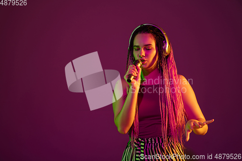 Image of Portrait of young caucasian woman on pink background with copyspace, unusual and freaky appearance