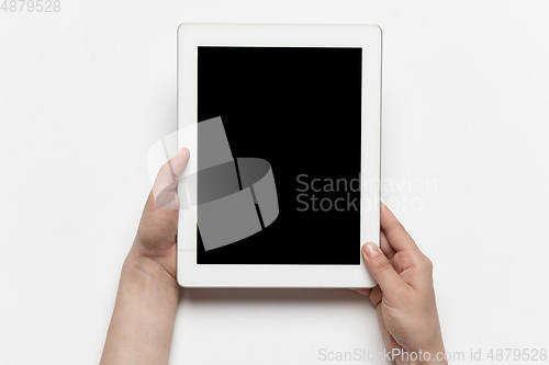 Image of Close up of human hand using tablet with blank black screen, education and business concept