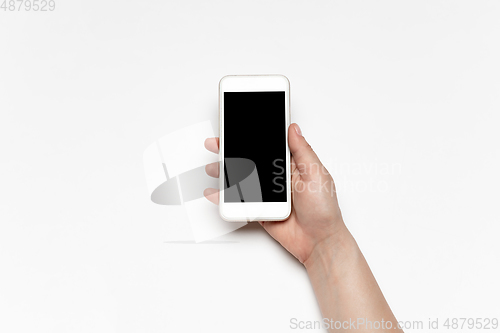 Image of Close up of human hand using smartphone with blank black screen, education and business concept