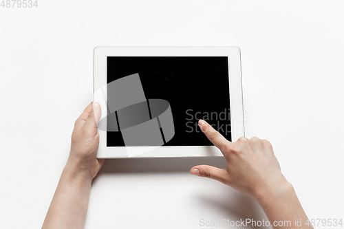 Image of Close up of human hand using tablet with blank black screen, education and business concept