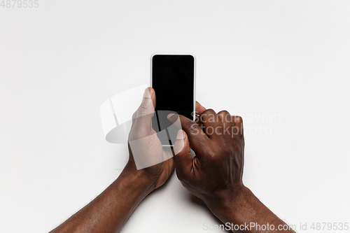 Image of Close up of human hand using smartphone with blank black screen, education and business concept