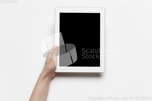 Image of Close up of human hand using tablet with blank black screen, education and business concept