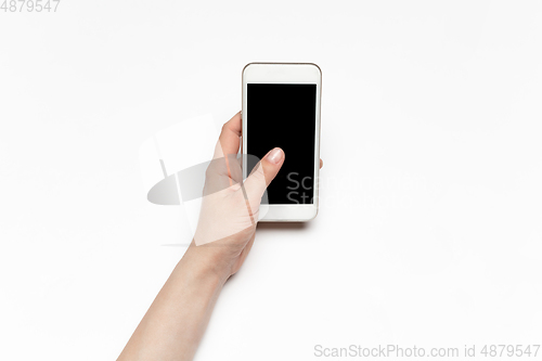 Image of Close up of human hand using smartphone with blank black screen, education and business concept