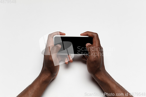 Image of Close up of human hand using smartphone with blank black screen, education and business concept