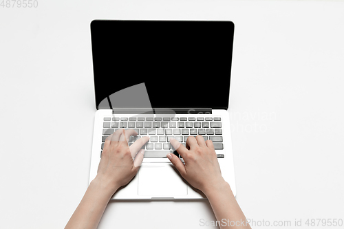 Image of Close up of human hand using laptop with blank black screen, education and business concept