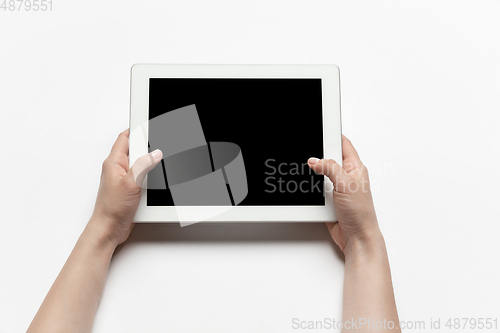 Image of Close up of human hand using tablet with blank black screen, education and business concept
