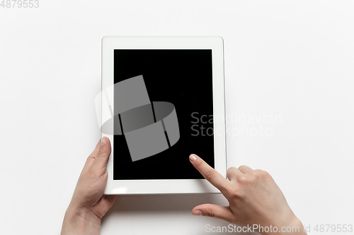 Image of Close up of human hand using tablet with blank black screen, education and business concept