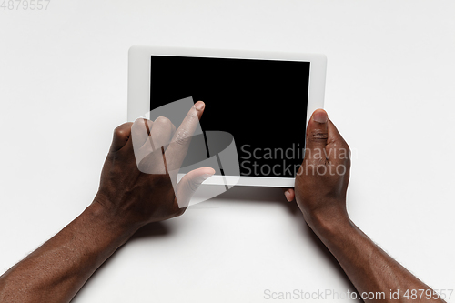 Image of Close up of human hand using tablet with blank black screen, education and business concept